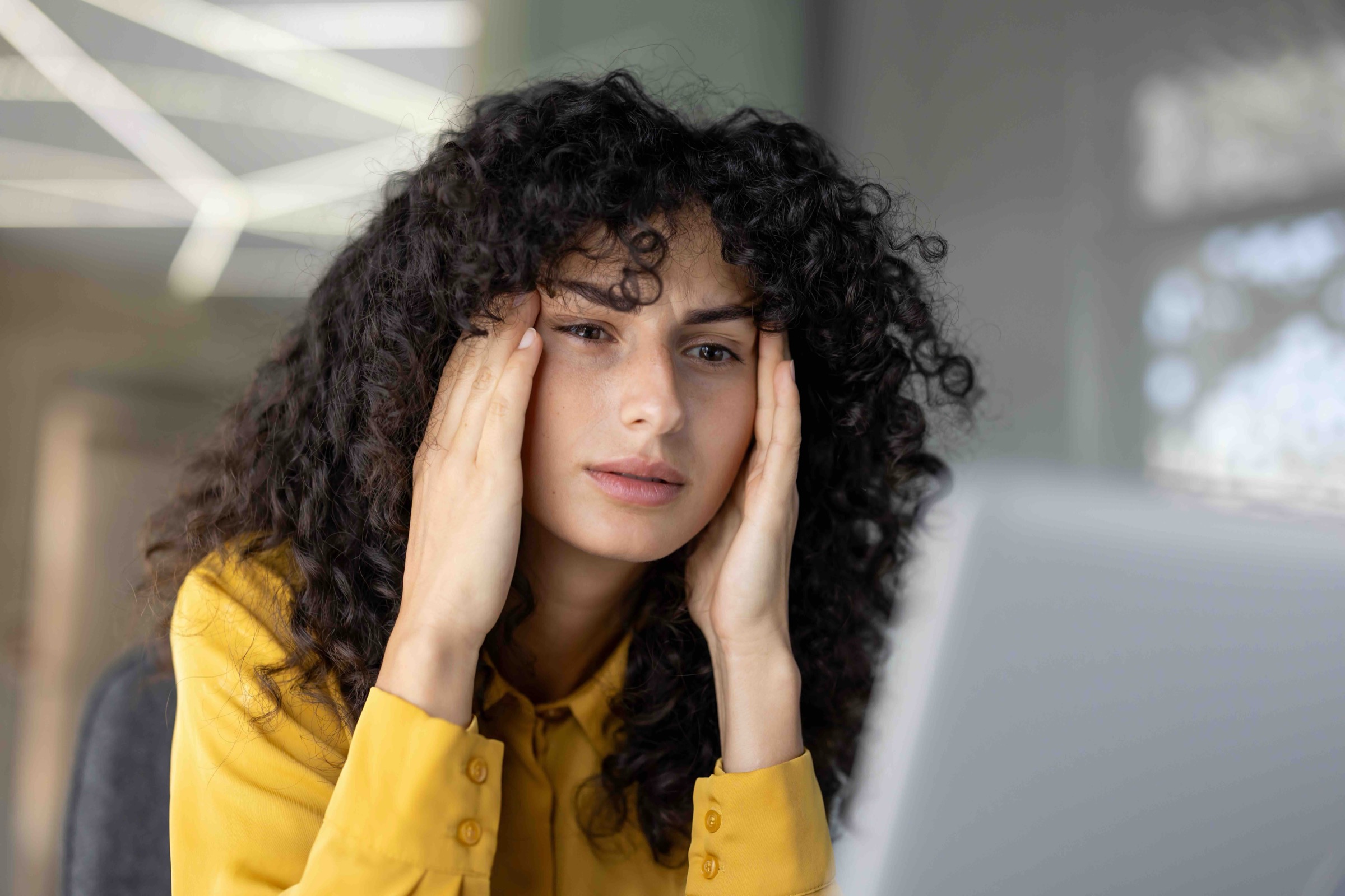 woman is overloaded and overtired at workplace inside office