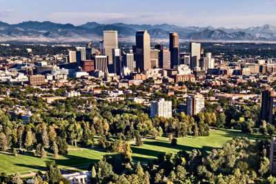 Denver Colorado skyline from the air, with Cheesman park in the foreground, the flatirons in the background