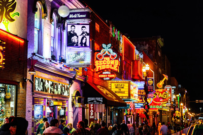 Famous Neon signs of blues clubs on Beale street illuminated at night in downtown Nashville, TN.