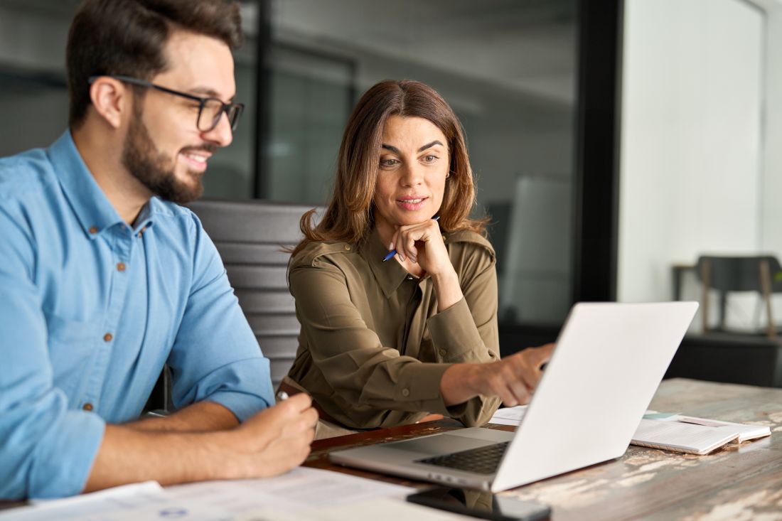 a businesswoman explaining digital software to a male client
