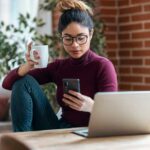 woman working from home distracted by her phone