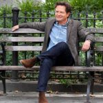 Michael J. Fox sitting on a bench