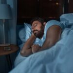 man sleeping in dark room