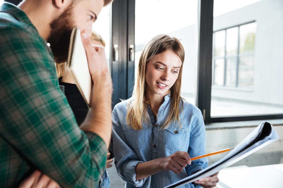 Professional woman showing man how he made a mistake