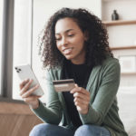 woman holding phone and credit card