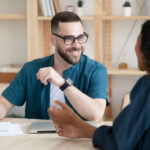 man using tips to speak better in conversation with colleague