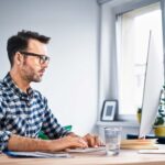 man managing email at computer