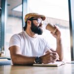 man writing in a cafe