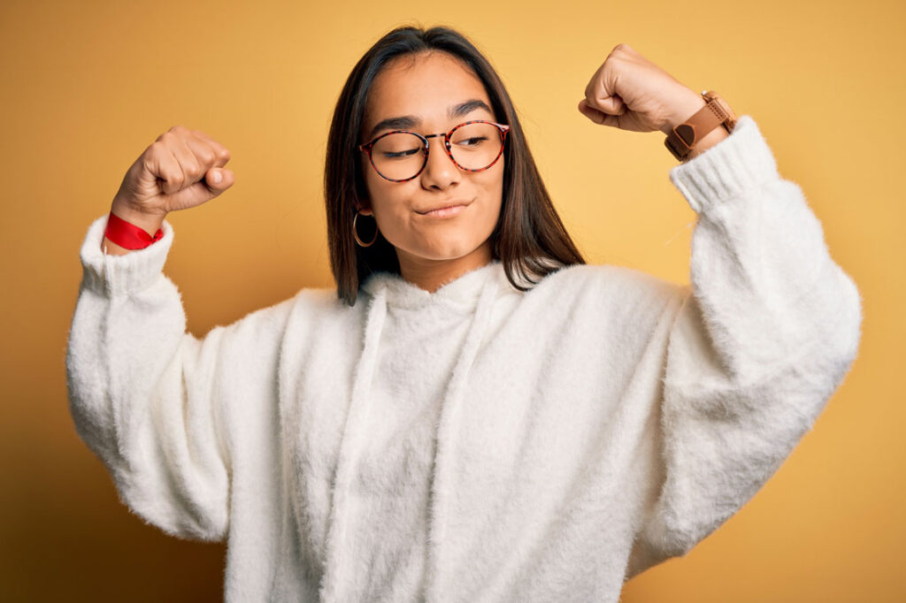 Young woman flexing quotes about strength