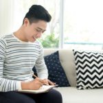 young man doing daily journaling