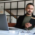 man reading book of poems about success