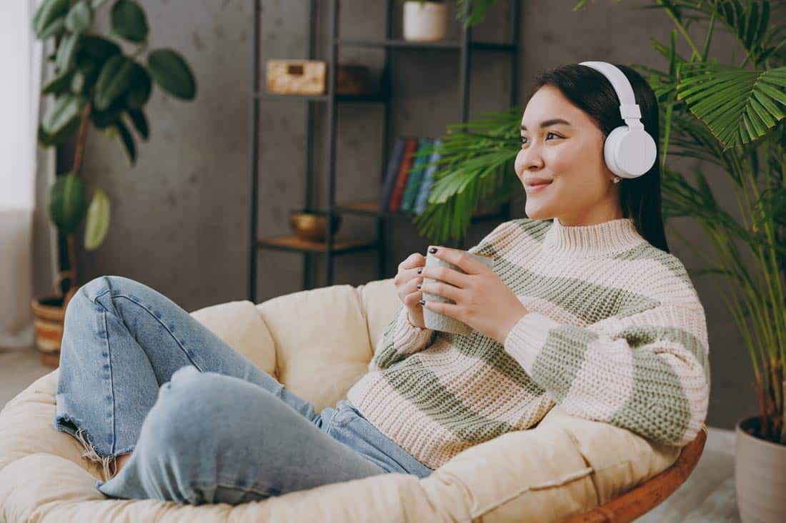 Woman listening to headphones on the couch