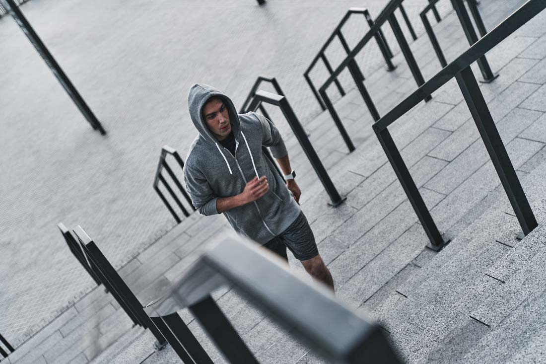 young man running up steps who will never give up