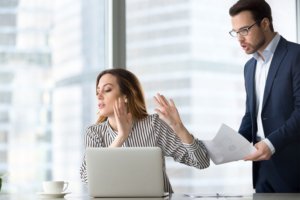 businesswoman refusing to accept report from coworker