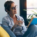 woman reading book to focus on personal growth and development