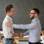 Team leader handshaking employee congratulating with professional achievement