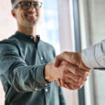 Two men shaking hands at meeting