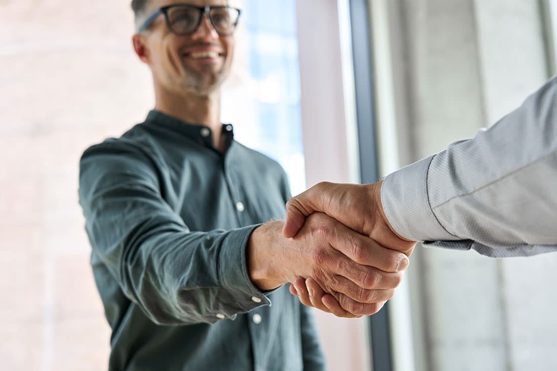 Two men shaking hands at meeting