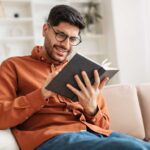 young man making time to read