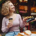 woman paying for coffee at cafe