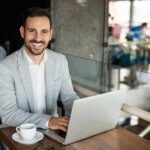 man working in coffee ship dressed for success