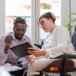 two colleagues analyzing productivity to maximize achievement