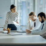 angry woman yelling at two male coworkers