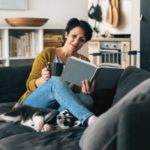 woman reading book for self-improvement