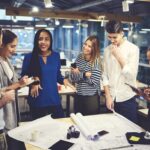 Photograph of a multiethnic group of colleagues discussing something as an example of emotional intelligence