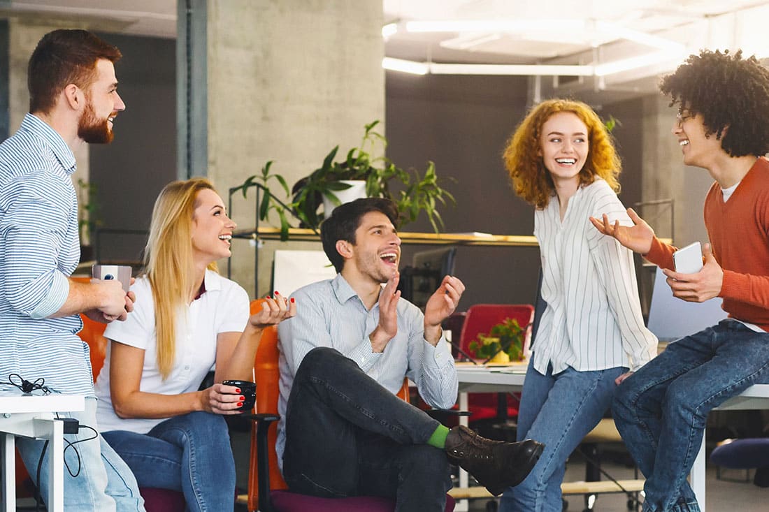 diverse group of people having talking at workplace setting