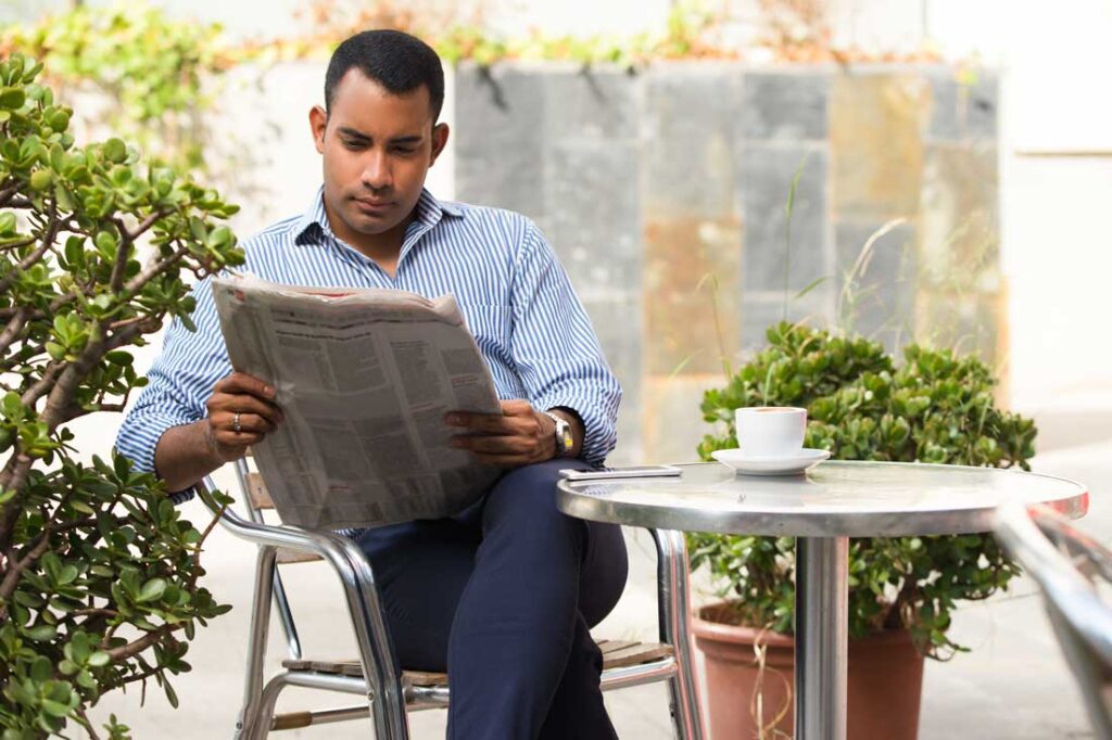 business manger reading the newspaper