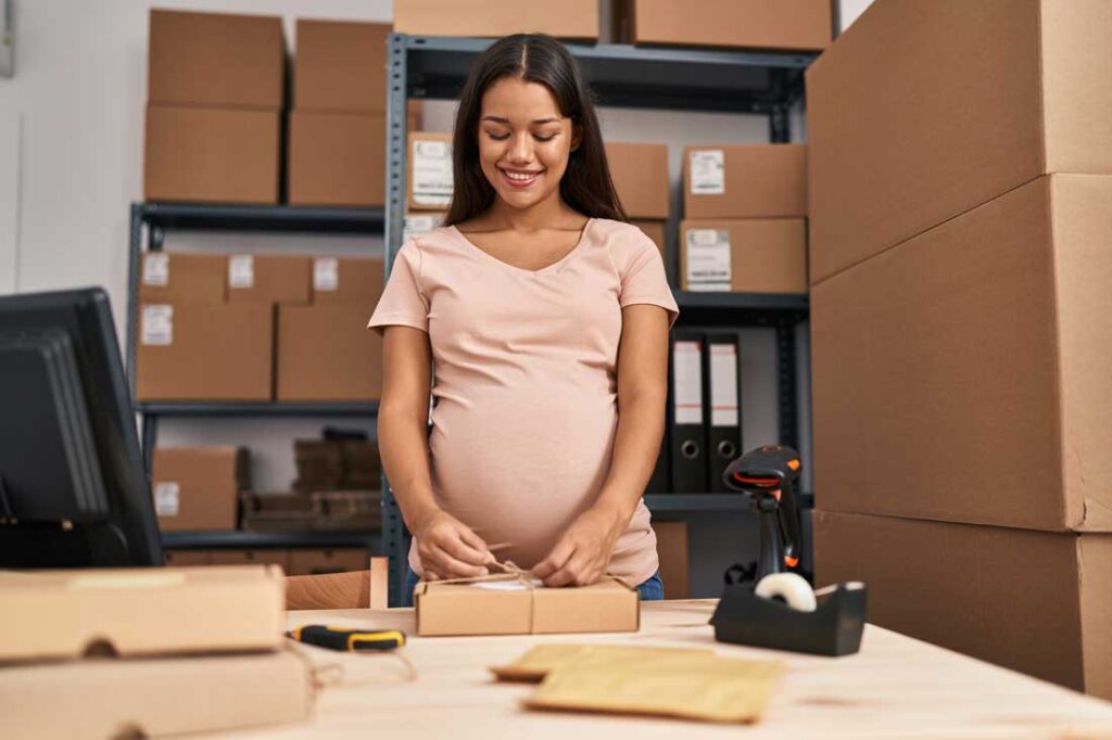 pregnant worker packing boxes