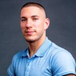 Photograph of Nick Santonastasso, a young handsome man with amelia in a light blue collared shirt, on how to recover from burnout