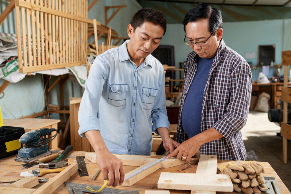 man working with father in the family carpentry business