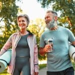 Happy older couple outdoors doing their self care routine