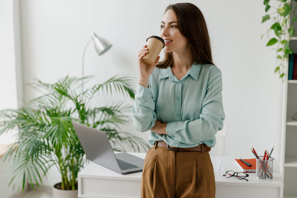 woman thriving at work drinking coffee