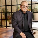 GoDaddy founder Bob Parsons sitting in a sunlit room and smiling at the camera