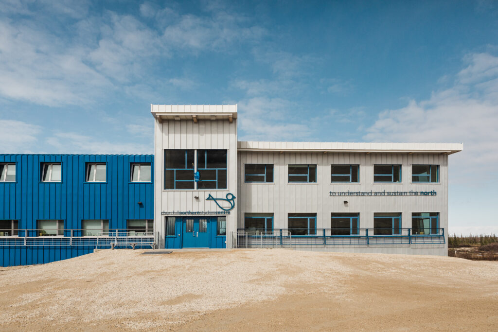 Image of the front of the blue and cream colored Churchill Northern Studies Centre building