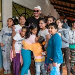 Socorro Tequila owner surrounded by school children from Jalisco, Mexico after donating cases of water