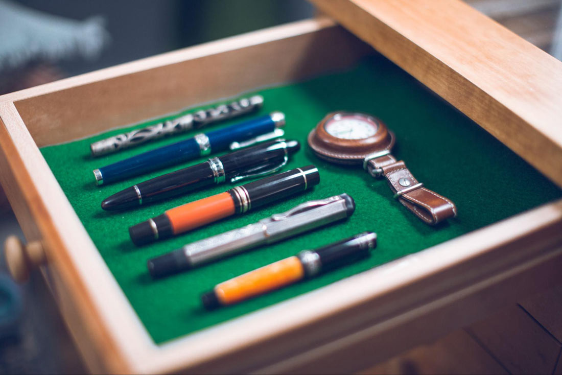 Pens and a watch lined up