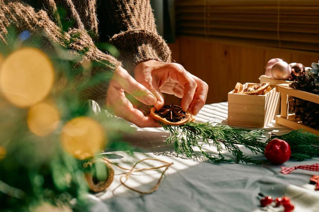 Closeup of a woman's hands making her own Christmas gifts because she's learning how to save money this holiday season