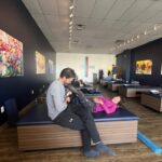 StretchLab flexologist uses technology to stretch a client