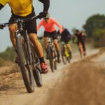 Cyclists riding on a dirt path learning life and business lessons from adventure racing