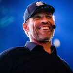 close-up image of Tony Robbins speaking at an event