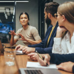 Coworkers engaging in healthy workplace conflict, creative abrasion, in the board room