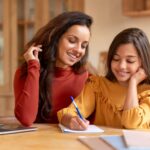 Mother and daughter sitting together learning how to make goal setting for kids