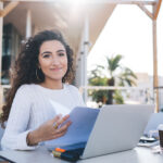 Woman on her computer outside learning how to use chatgpt