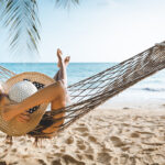 woman on vacation in hammock on beach