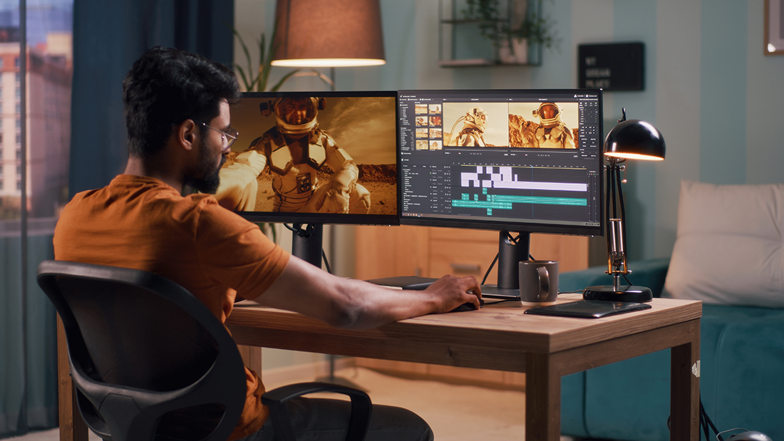 Man sitting at computer editing video