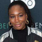 Celebrity franchises owner Venus Williams smiling in a black and silver jacket